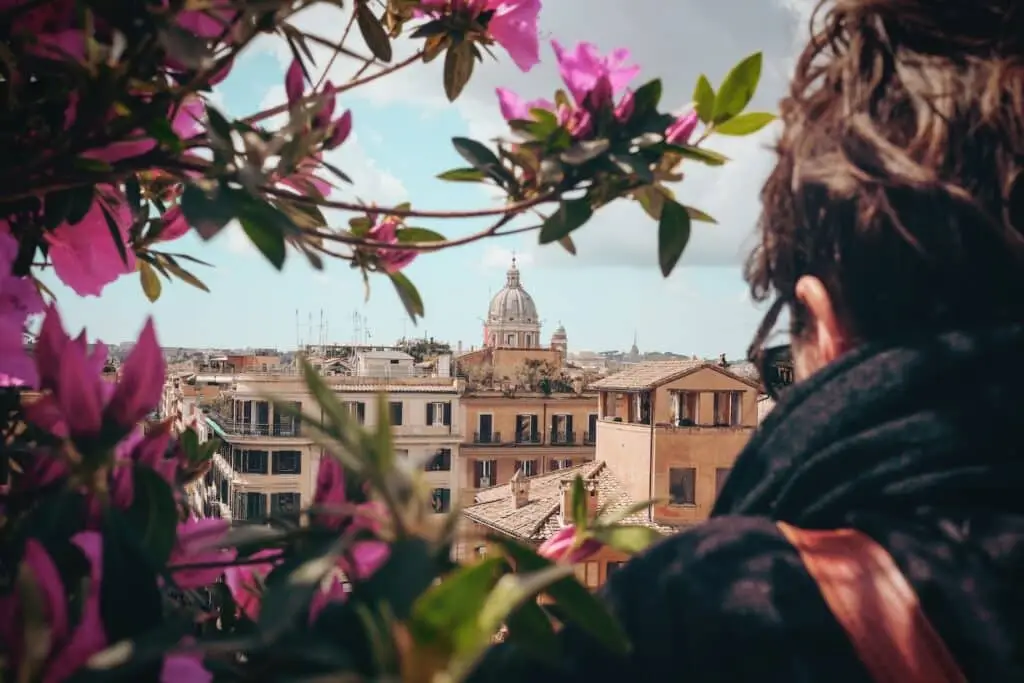 selective focus photography of man facing concrete building during dayitme