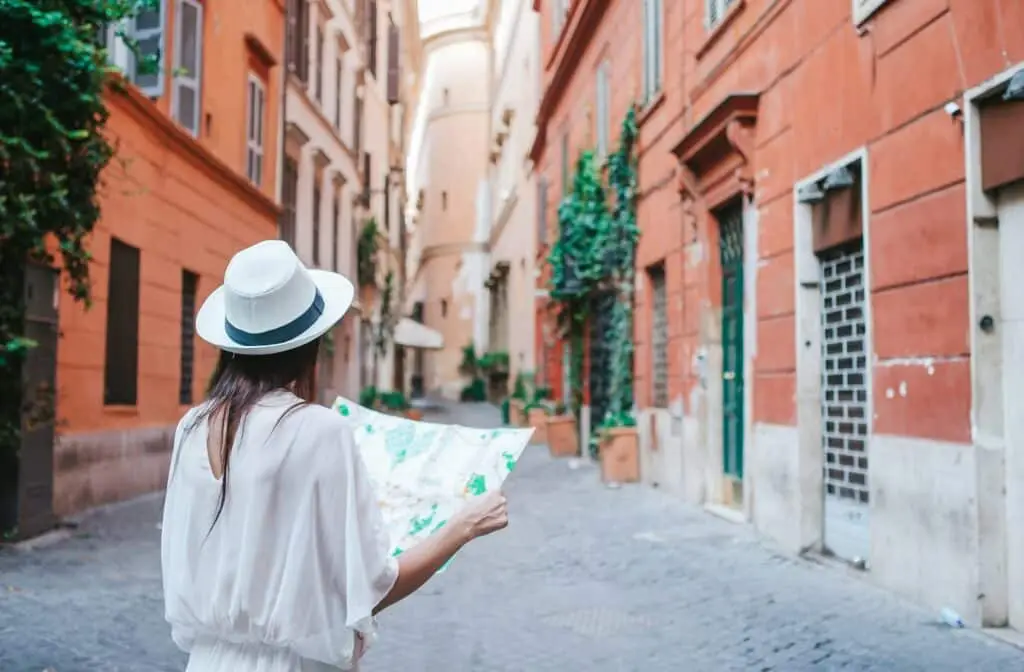 Travel tourist woman with map in Rome outdoors during holidays in Europe